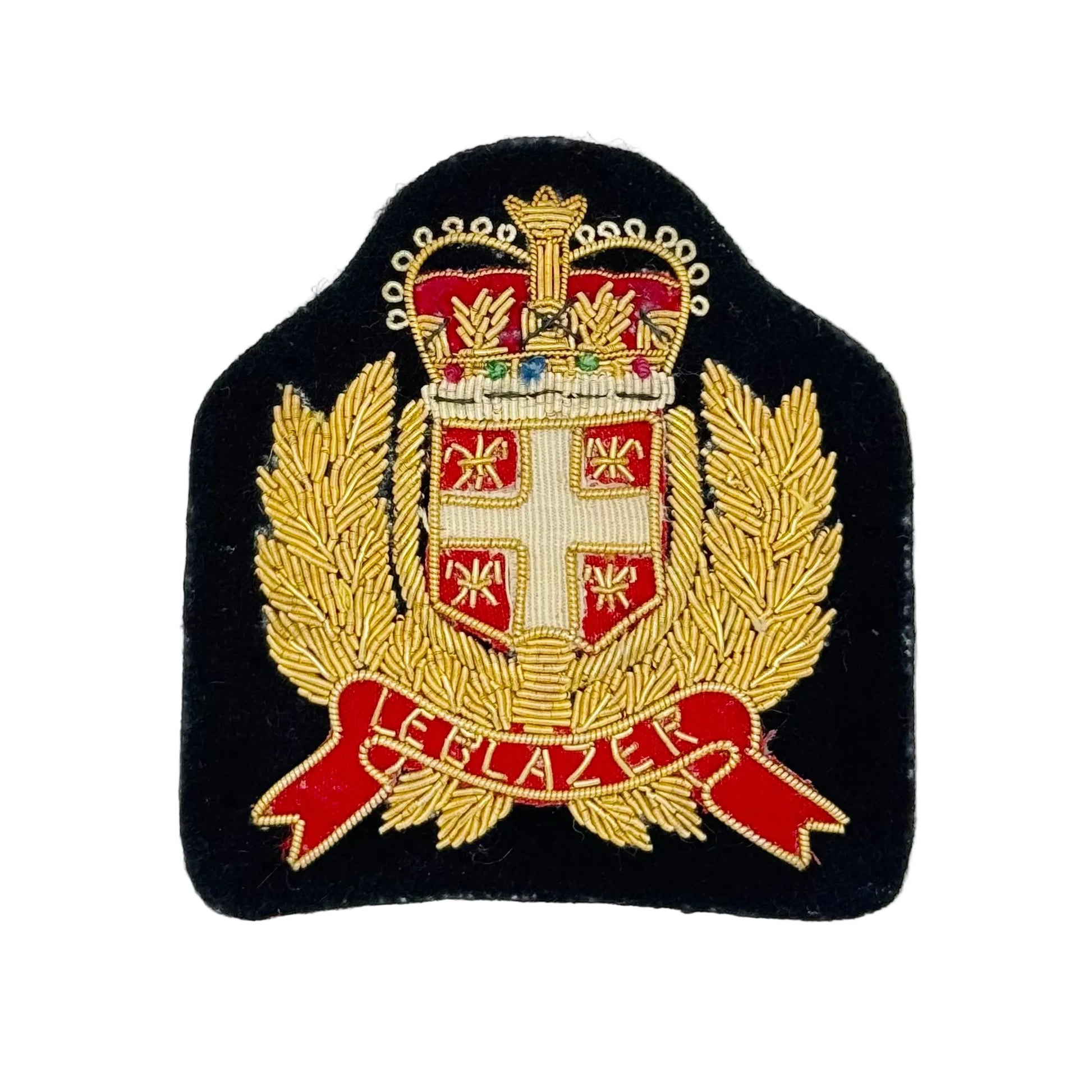An embroidered military-style crest patch on a black fabric background, featuring a gold crown, laurel branches, a white cross on a red shield, and a red scroll with gold lettering, photographed against a plain white background.