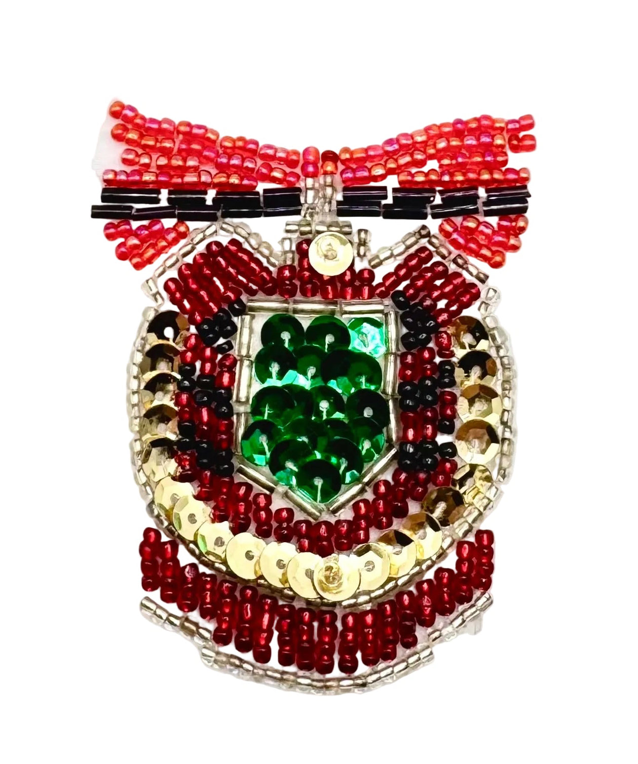A handcrafted beaded crest or badge featuring a green sequin center, surrounded by red, black, and gold beads, with a red and black beaded ribbon bow at the top, set against a plain white background.