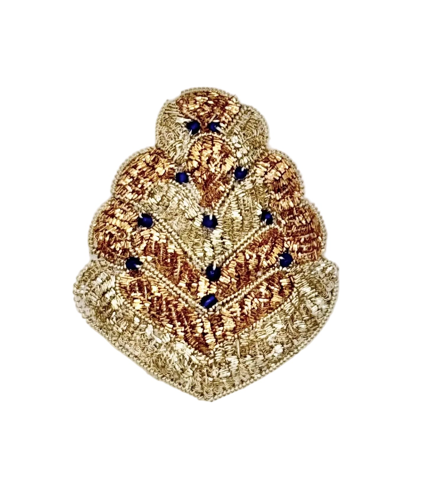 A decorative embroidered patch featuring a tiered, fan-like design in metallic gold and bronze threads, accented with small dark blue beads, set against a plain white background.