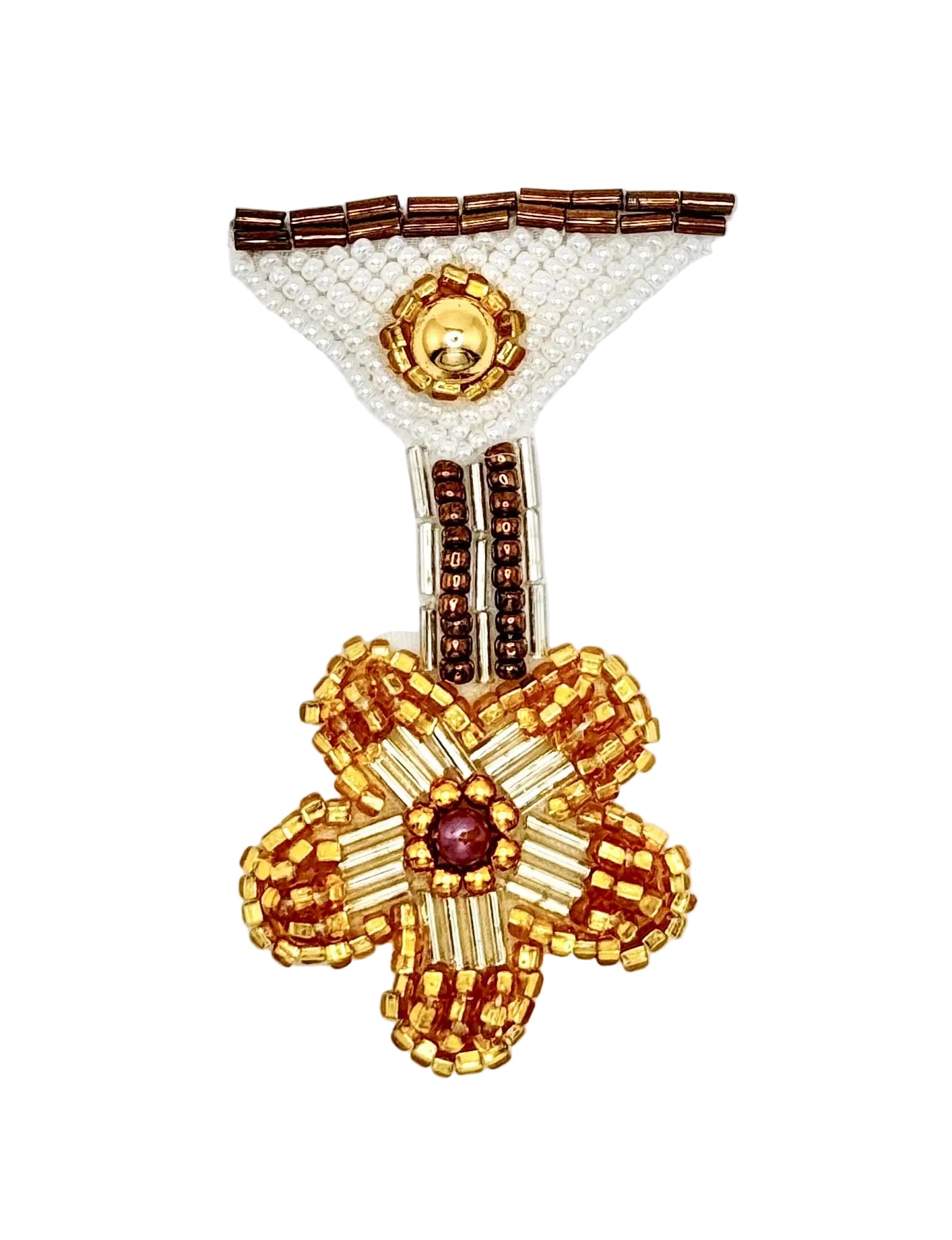 A handcrafted beaded medal motif featuring a large gold and brown flower with a central purple jewel, attached to a white beaded triangle with brown accents, photographed on a plain white background.