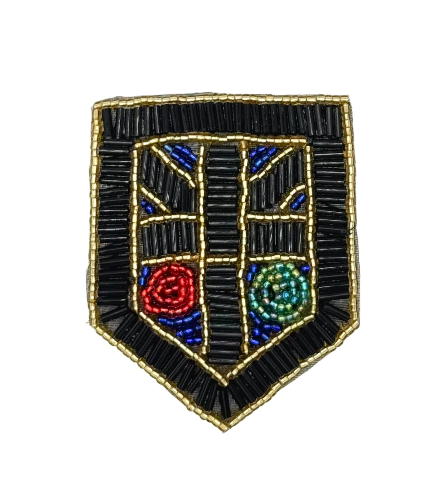 A shield-shaped beaded patch with a black beaded border and central design, featuring blue geometric accents and two circular motifs in red and green, on a plain white background.