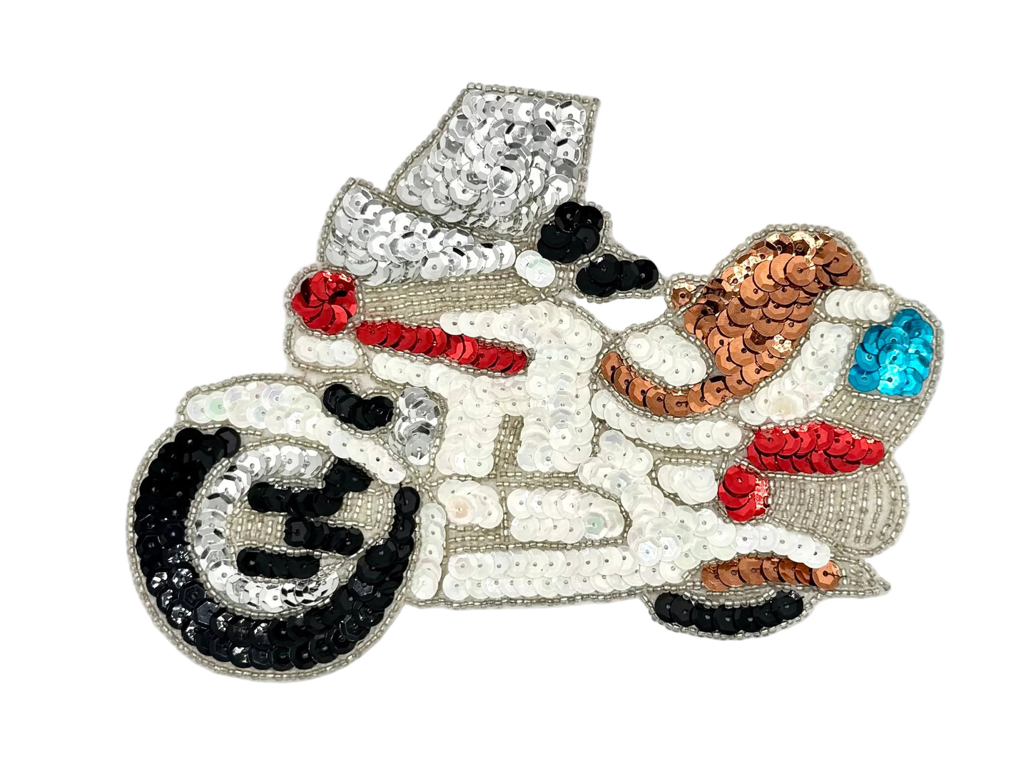 A motorcycle-shaped sequin patch on a plain white background. The patch features a silver, white, black, and brown sequin design with red and blue sequin accents.