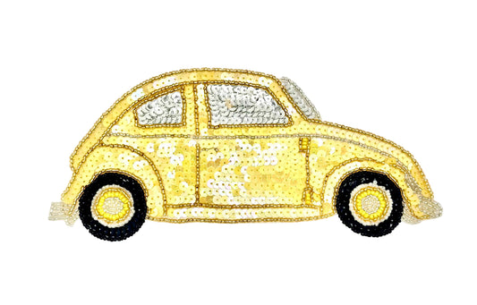 A vintage-style car patch or applique made from gold and silver sequins, with black wheels, shown on a plain white background.