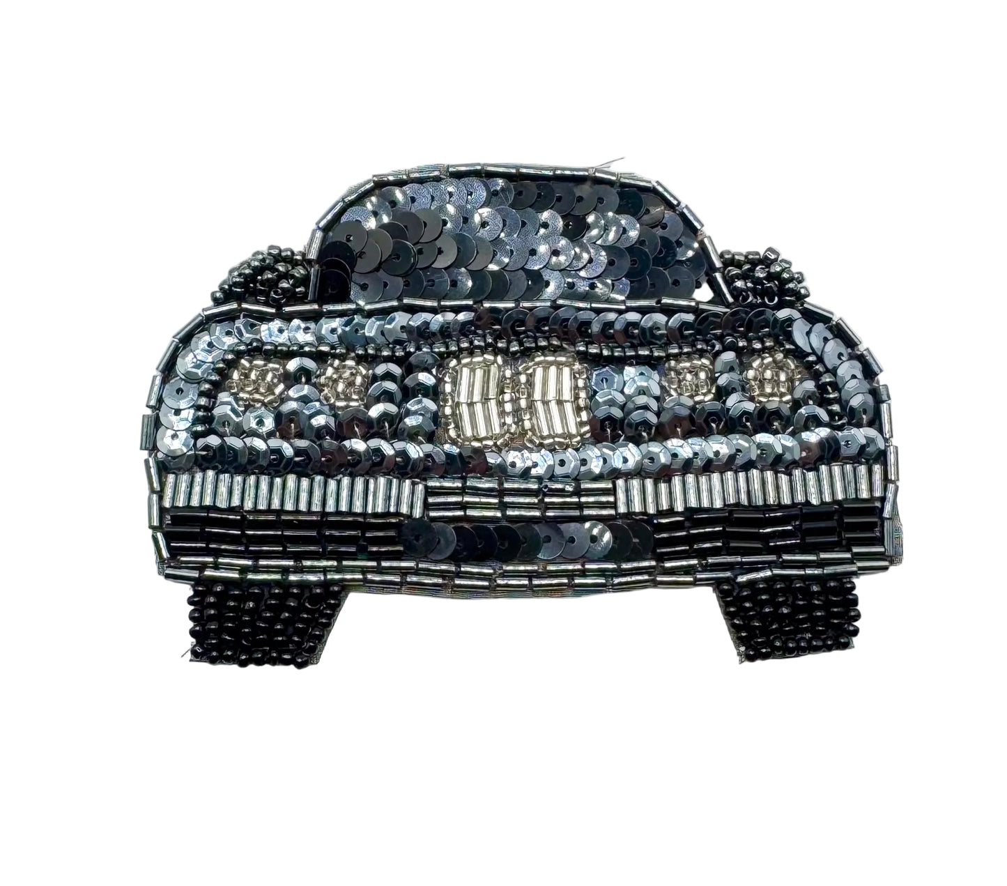 A decorative patch or applique shaped like a vintage car, covered in black, silver, and silver sequins and beads on a plain white background.