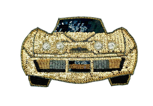 A decorative embroidered patch shaped like a sports car, covered in gold sequins and beads with black and silver details, on a plain white background.
