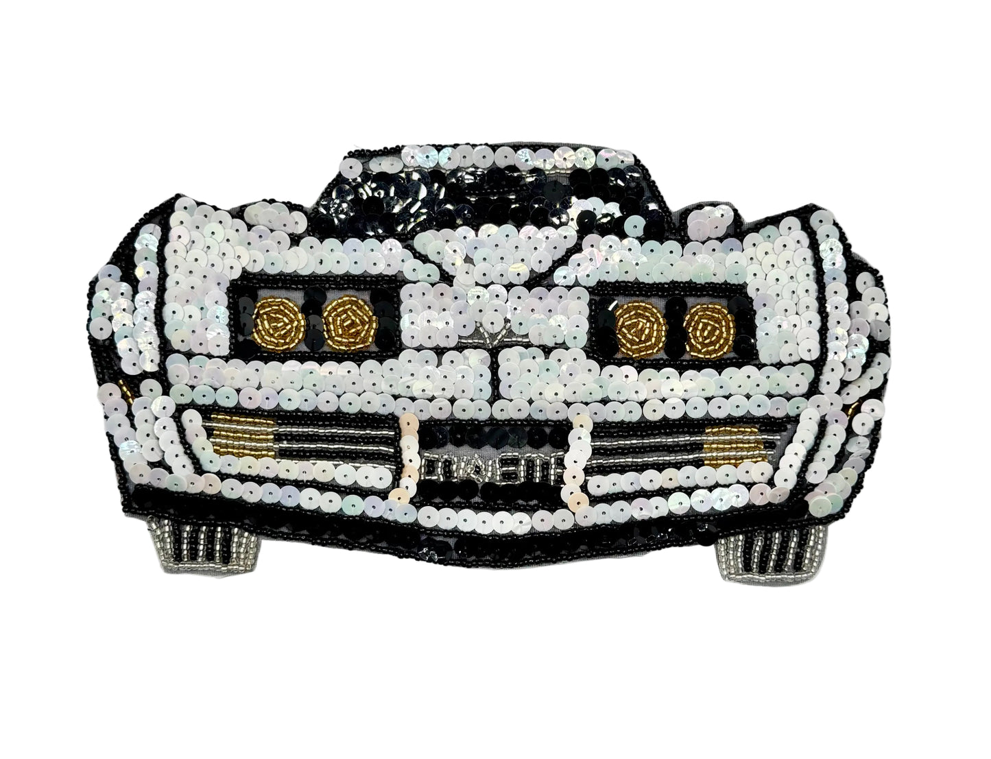 A vintage car-shaped sequin embellishment or patch featuring a black and white design with gold accents, including circular headlight details and a grille with the word 'CORVETTE' across the front.