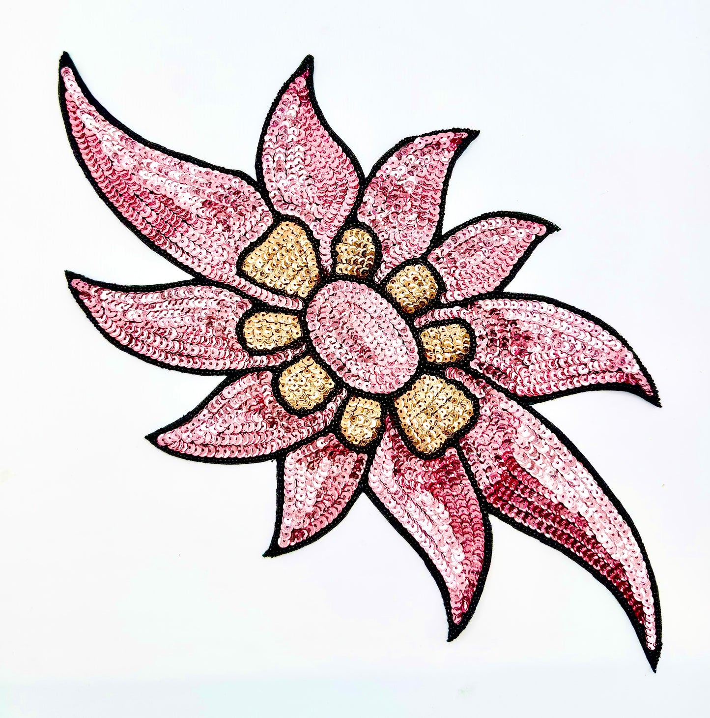 A stylized sequined flower motif with pink petals outlined in black, a pink center, and tan/golden center details on a plain white background.