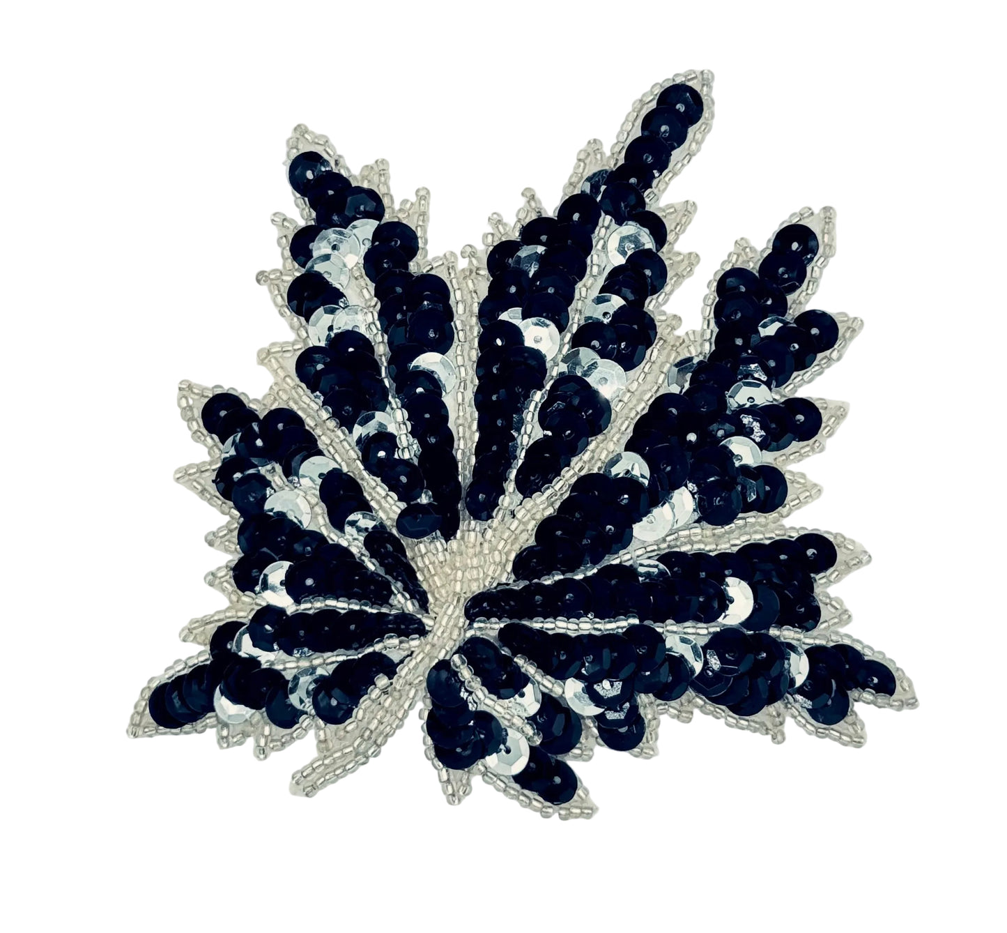 A decorative sequin applique shaped like a leaf or feather, featuring black and silver sequins with silver beads, shown on a plain off-white background.