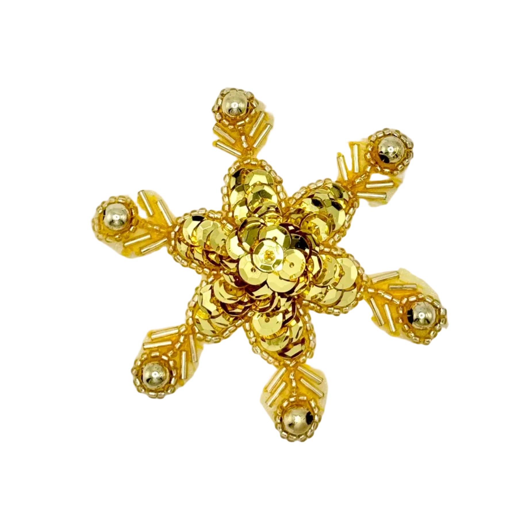 Gold sequin and bead snow flakes on a white background.