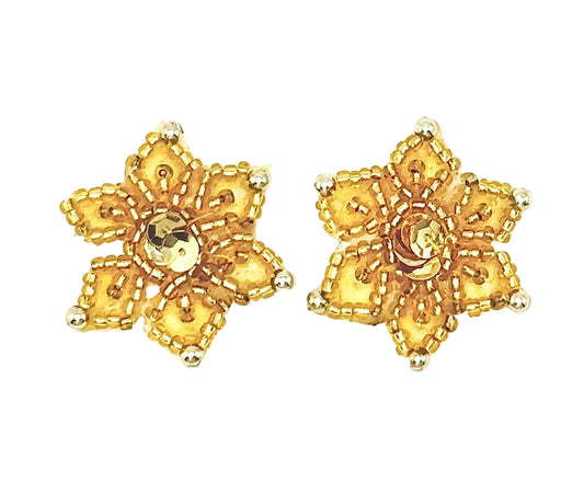A pair of gold beaded snowflake appliqués with intricate beaded detailing and central faceted sequins shown on a plain white background.