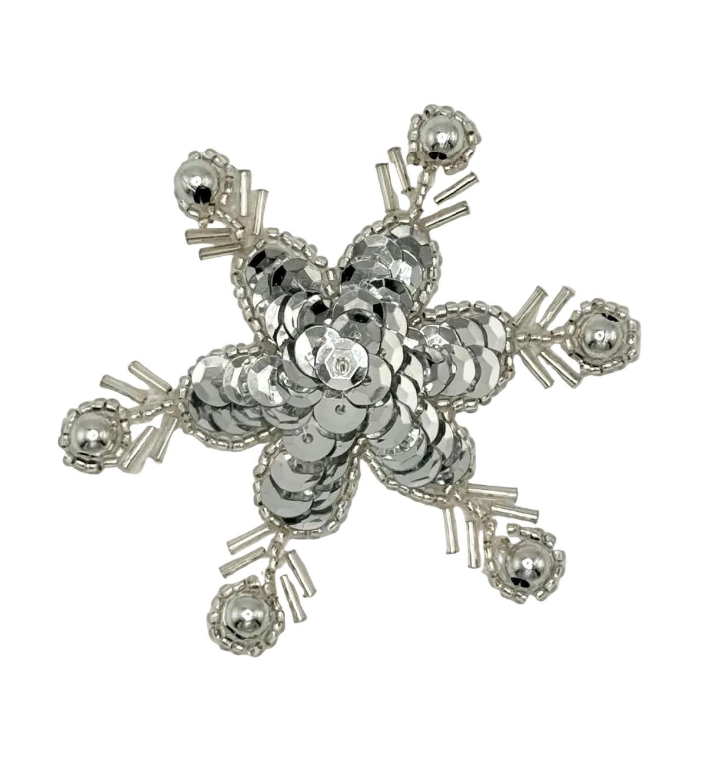 Silver sequin and bead snow flakes on a white background.