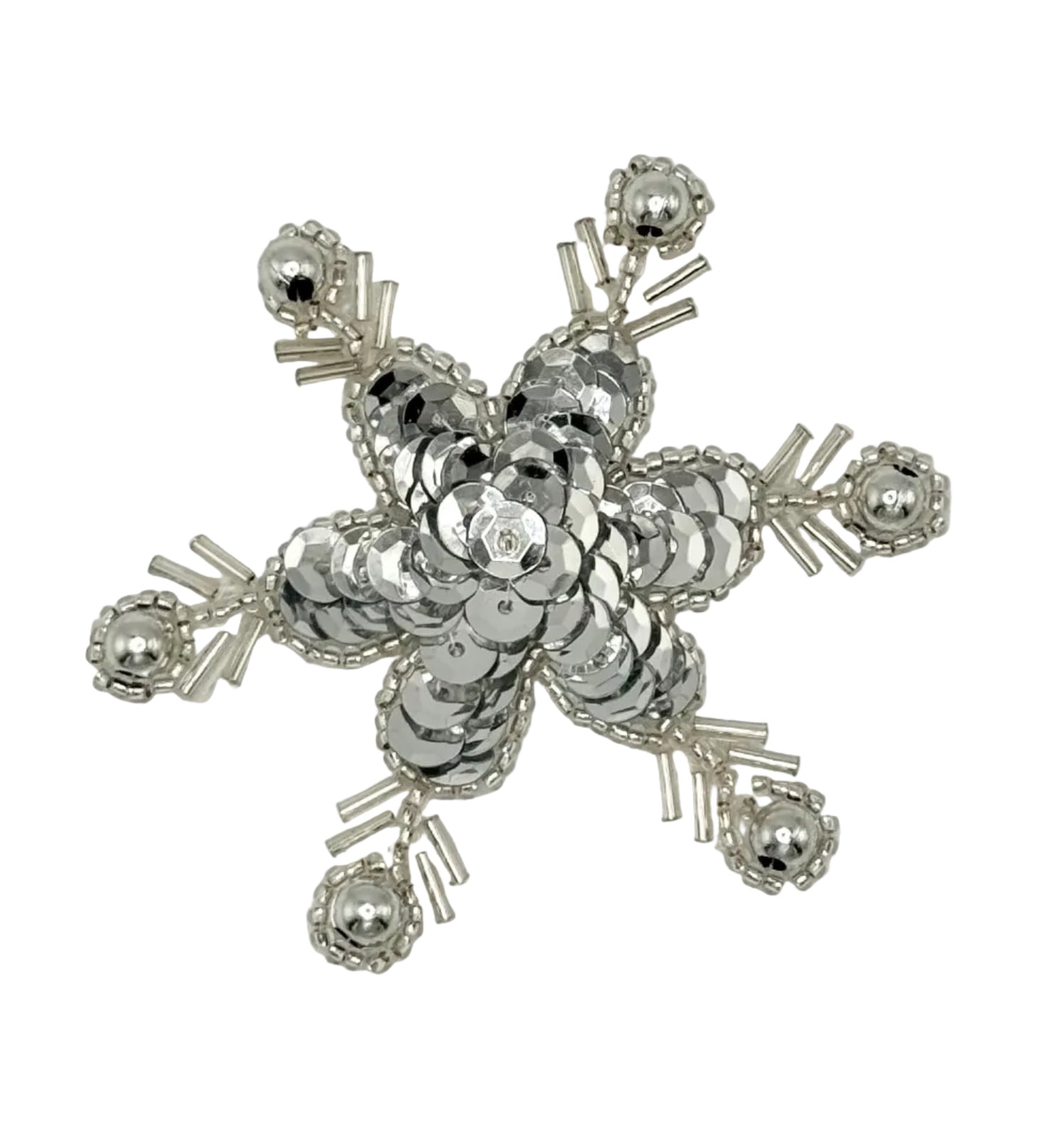 Silver sequin and bead snow flakes on a white background.