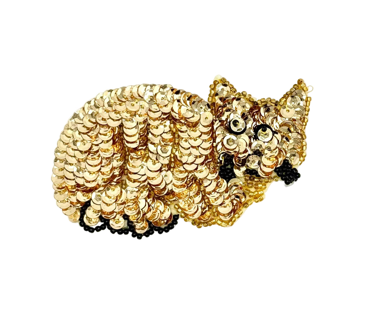 Gold sequin cat applique on q white background.