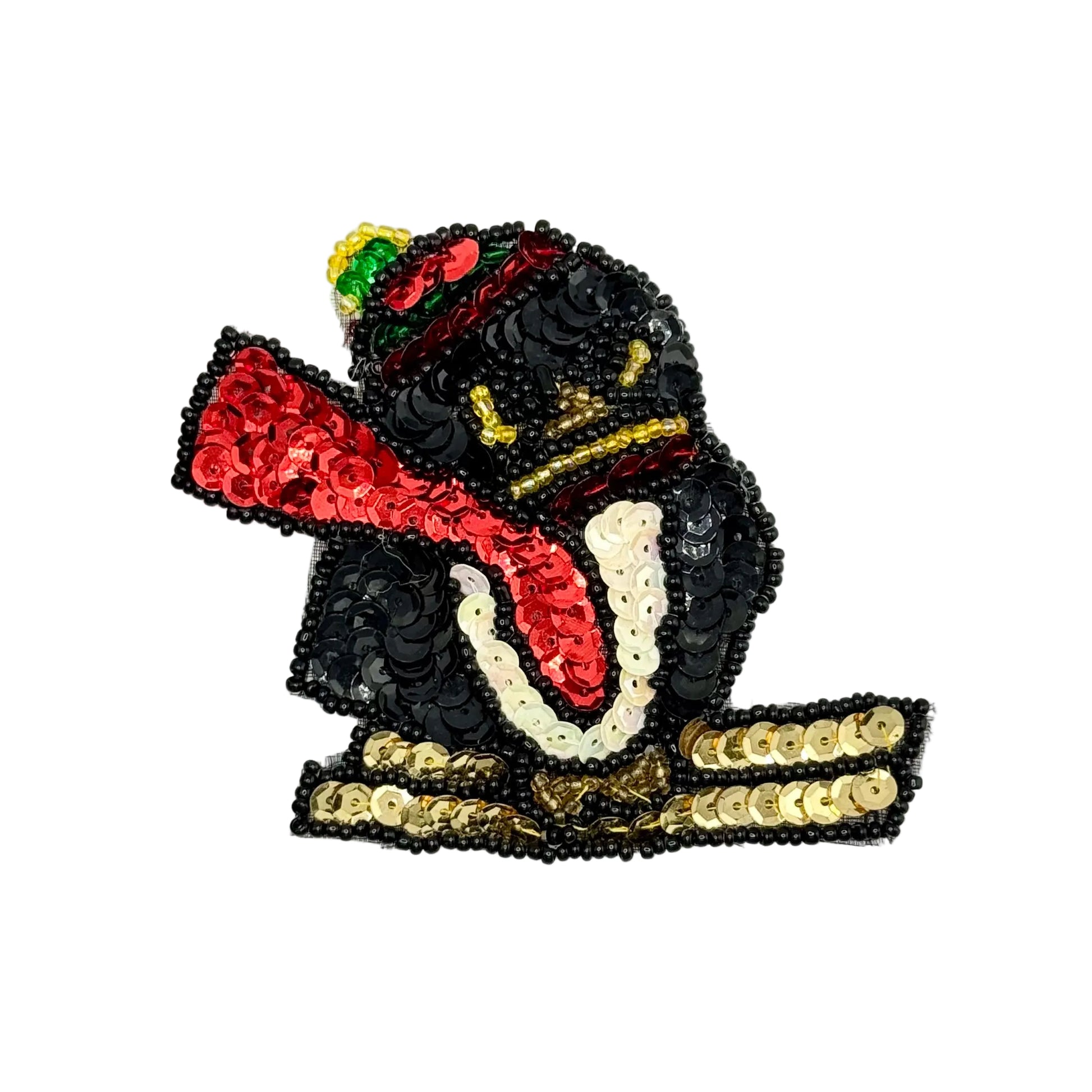 Sequin penguin skiing applique with sequins and beads on a white background.