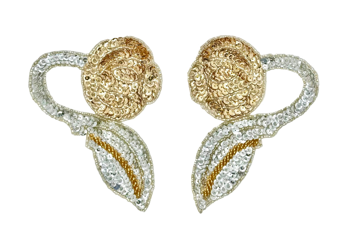 A pair of ornate floral embellishments featuring cupped gold and silver sequins and silver beadwork on a plain white background.