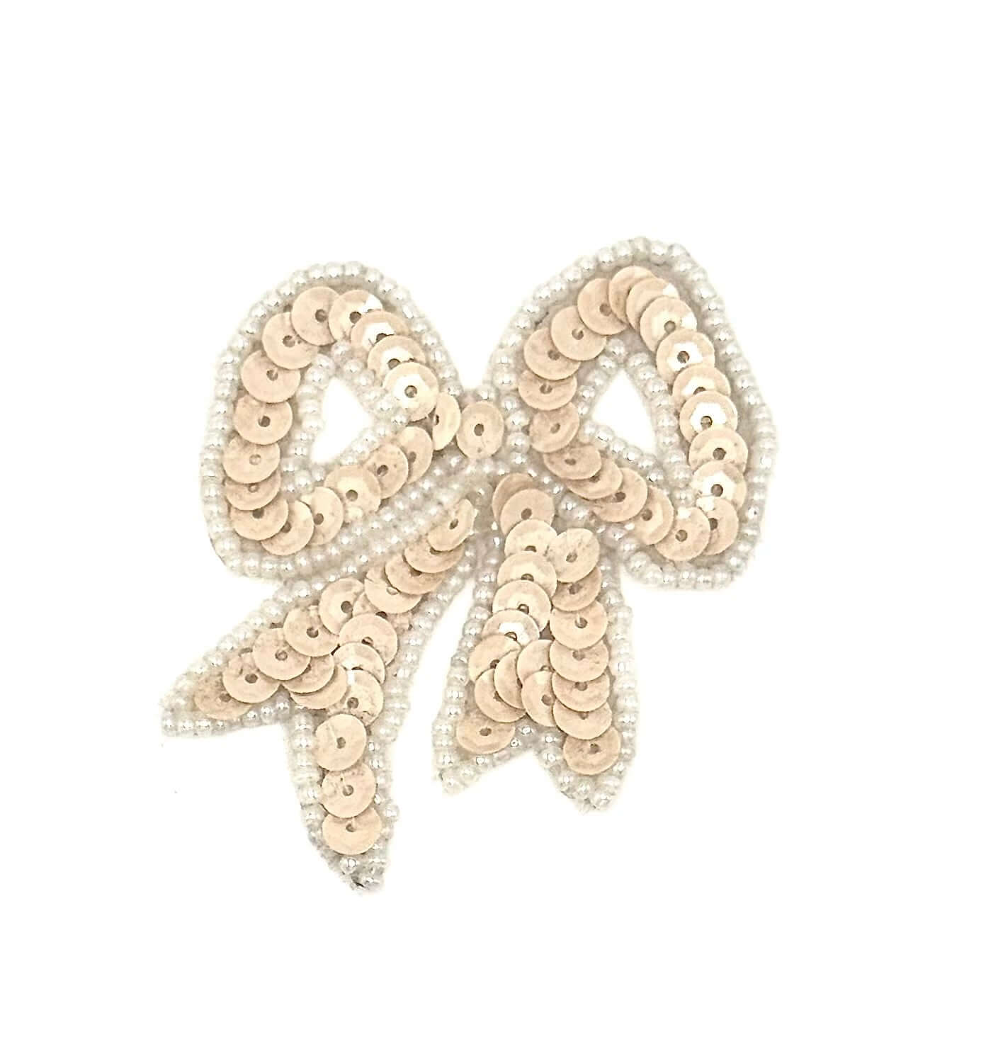 Sequined bow-shaped decorative item on a white background