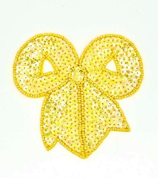 Yellow Sequin Bow on a white background