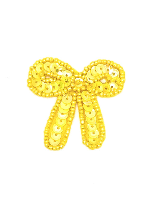 Yellow sequin bow on a white background