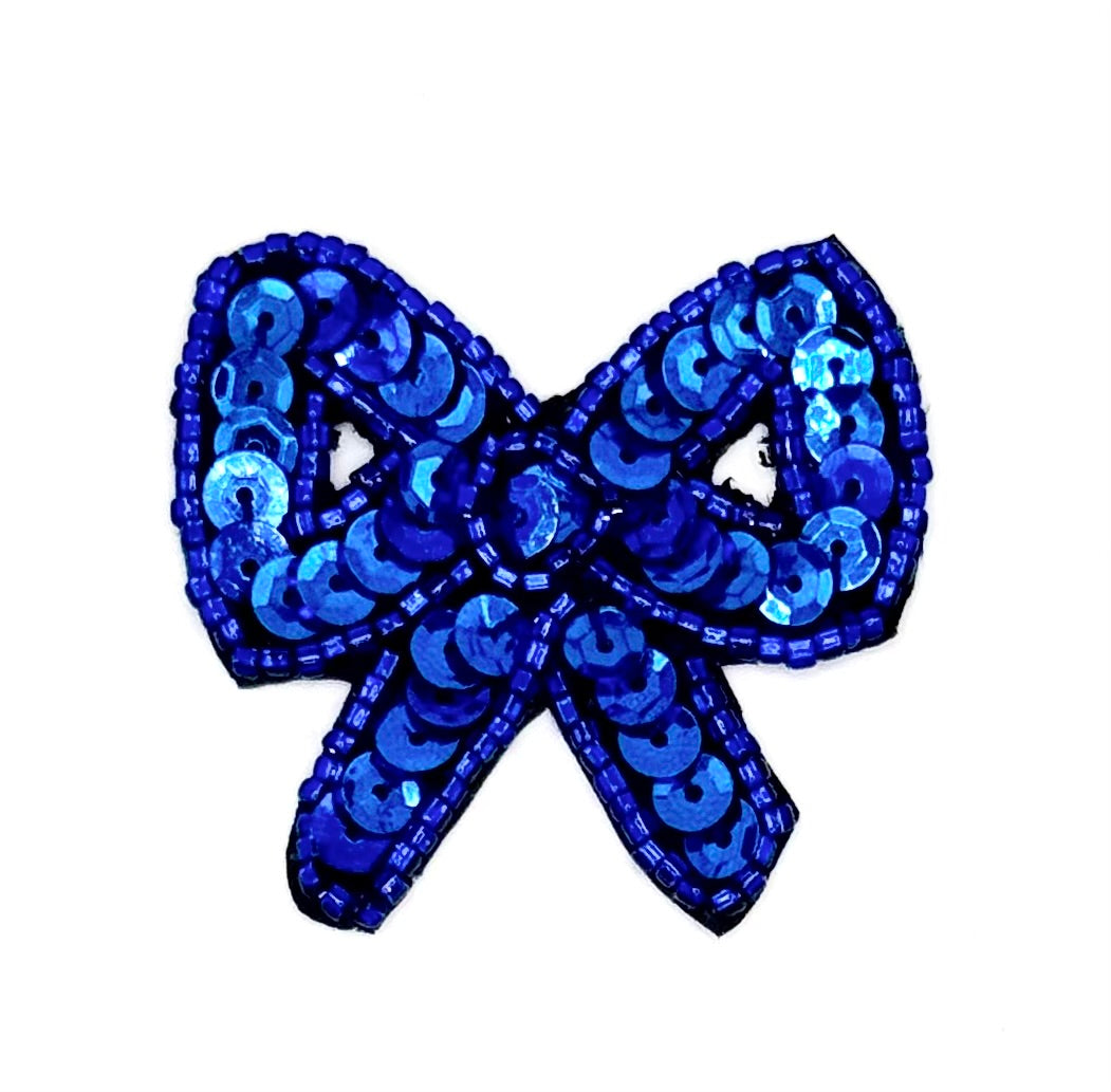 Blue sequin bow on a white background