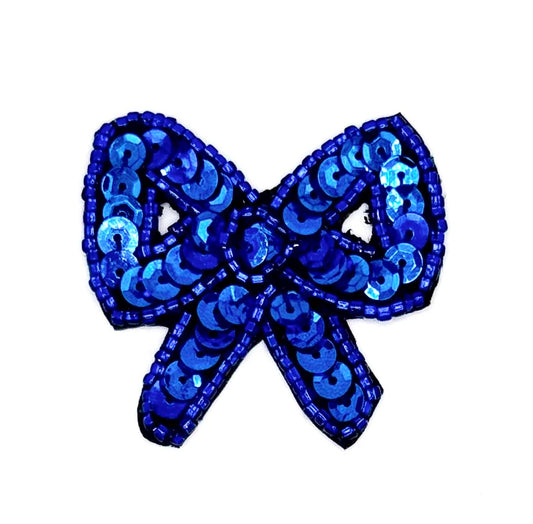 Blue sequin bow on a white background