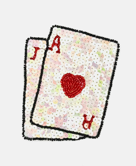 Two sequin playing cards with a heart design on a white background