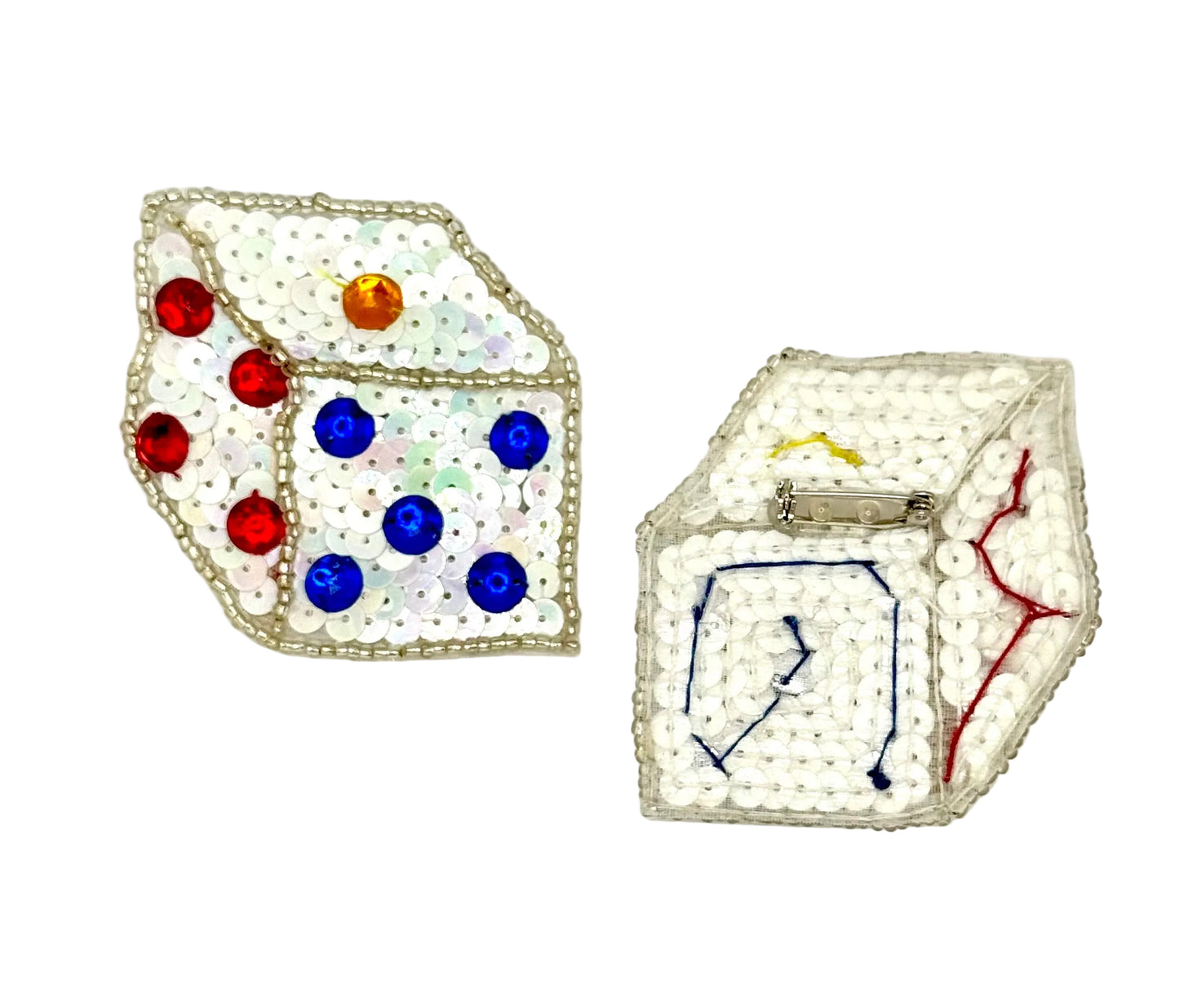 Pair of sequin dice-shaped patches with colorful gemstones on a white background showing pin back