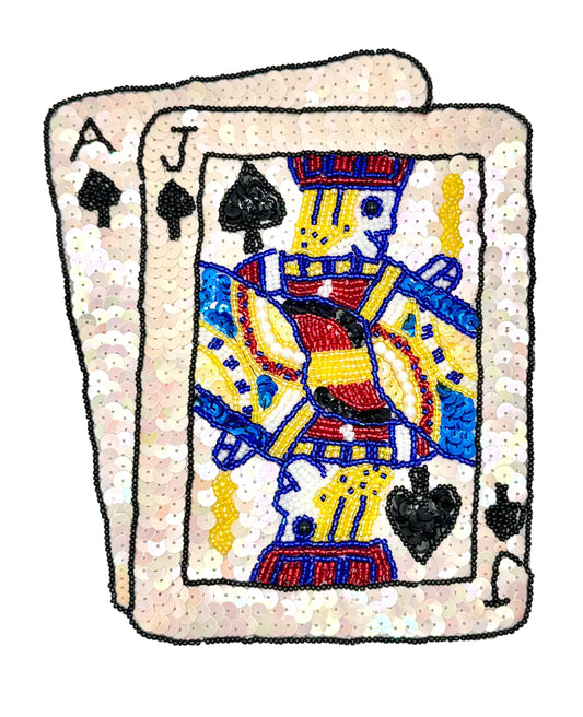 Sequined patch with an Ace and Jack of Spades on a white background