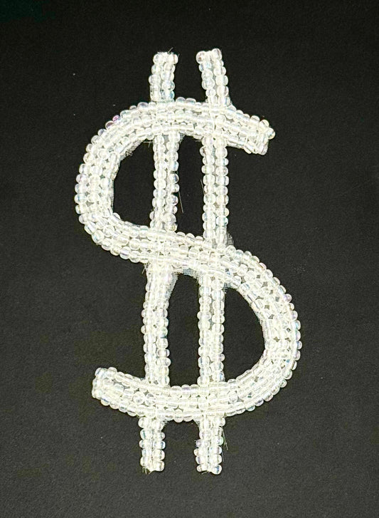 Dollar sign symbol made of white beads on a black background
