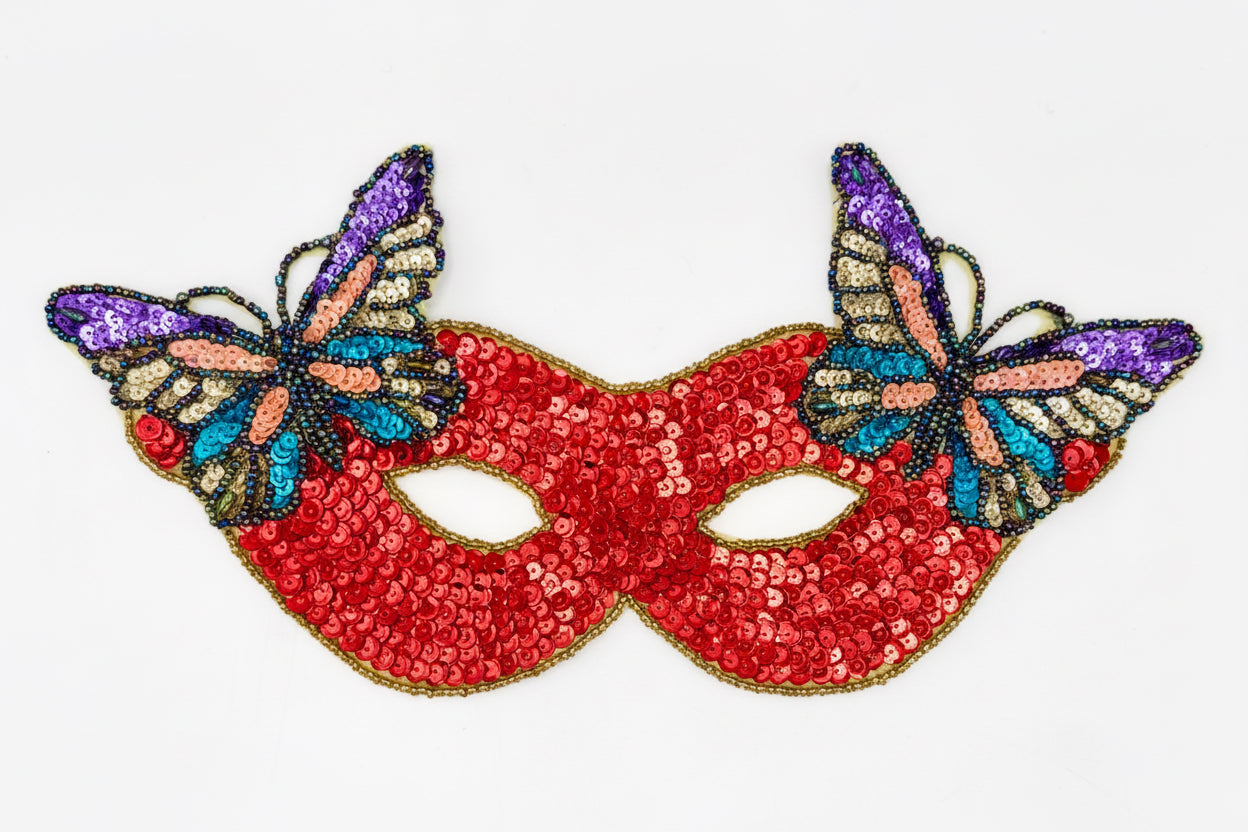 Red sequin mask with butterfly decorations on a white background