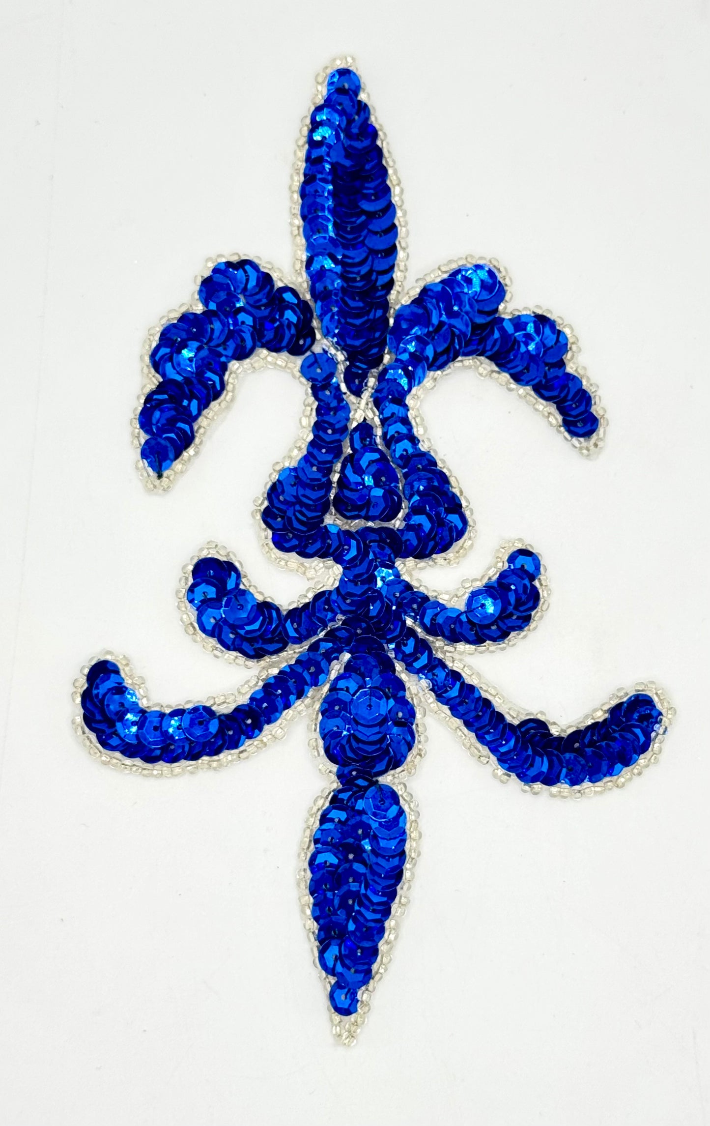 Blue decorative fleur-de-lis design on a white background