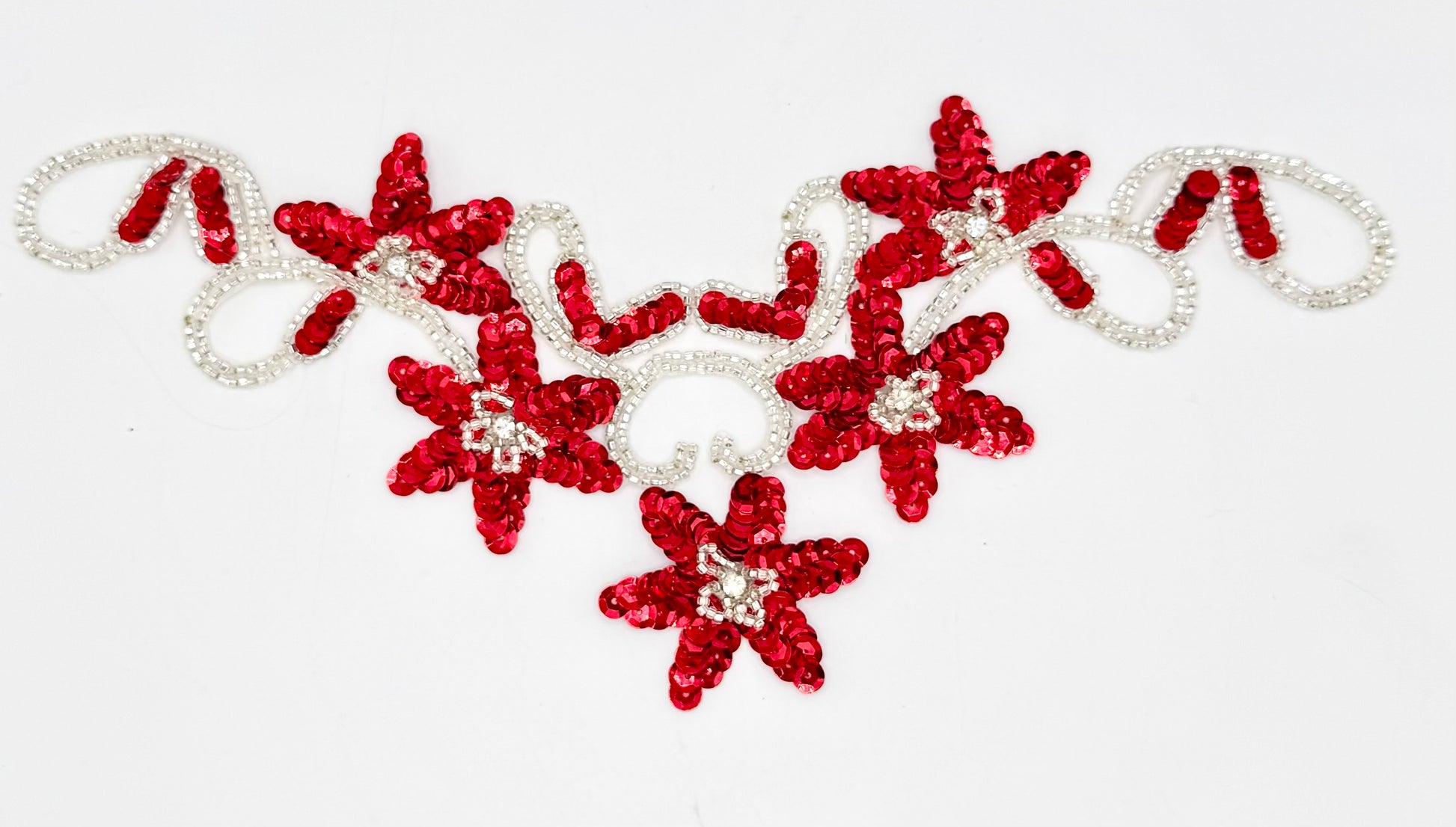 Red flower-shaped sequin neckpiece with silver beads and five rhinestones on a white background