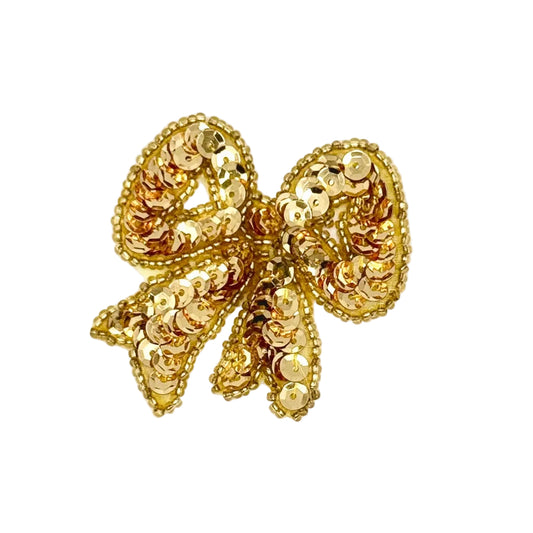 Gold bow with gold sequins and beads on a white background