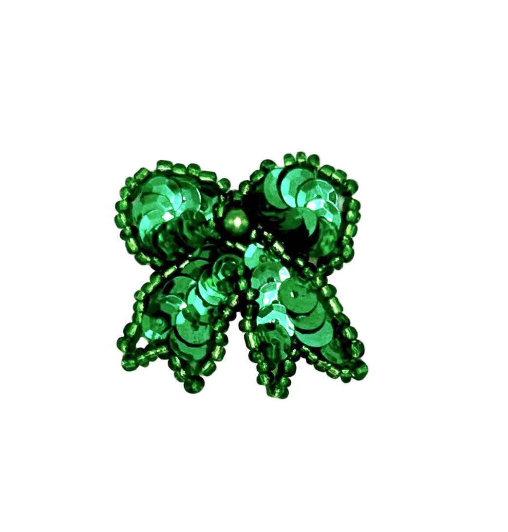 Green beaded sequin bow on a white background