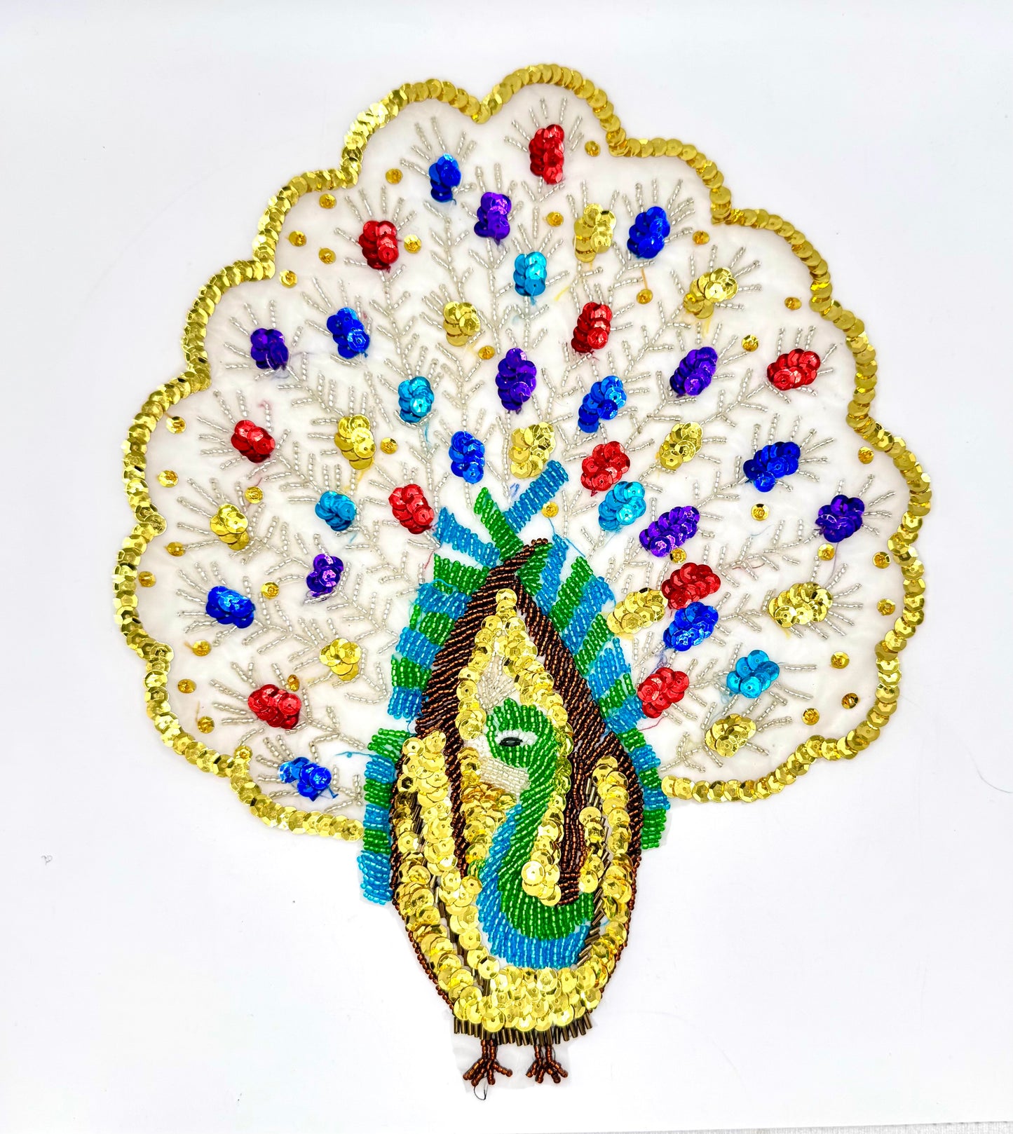Decorative peacock with colorful beads and sequins on a white background