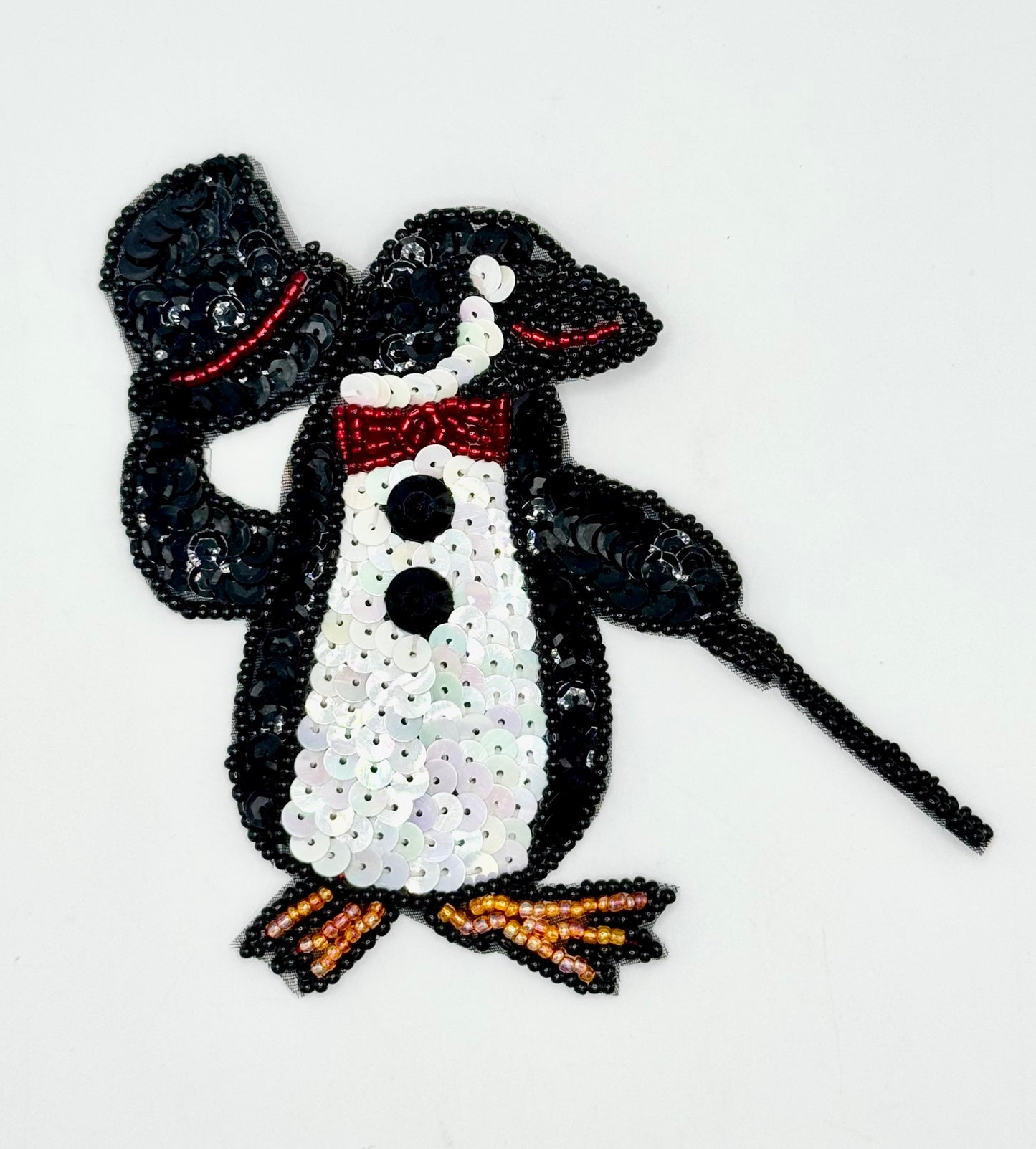 Sequined penguin design on a white background