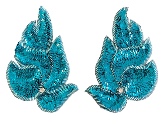 Two turquoise sequin leaf patches on a black background