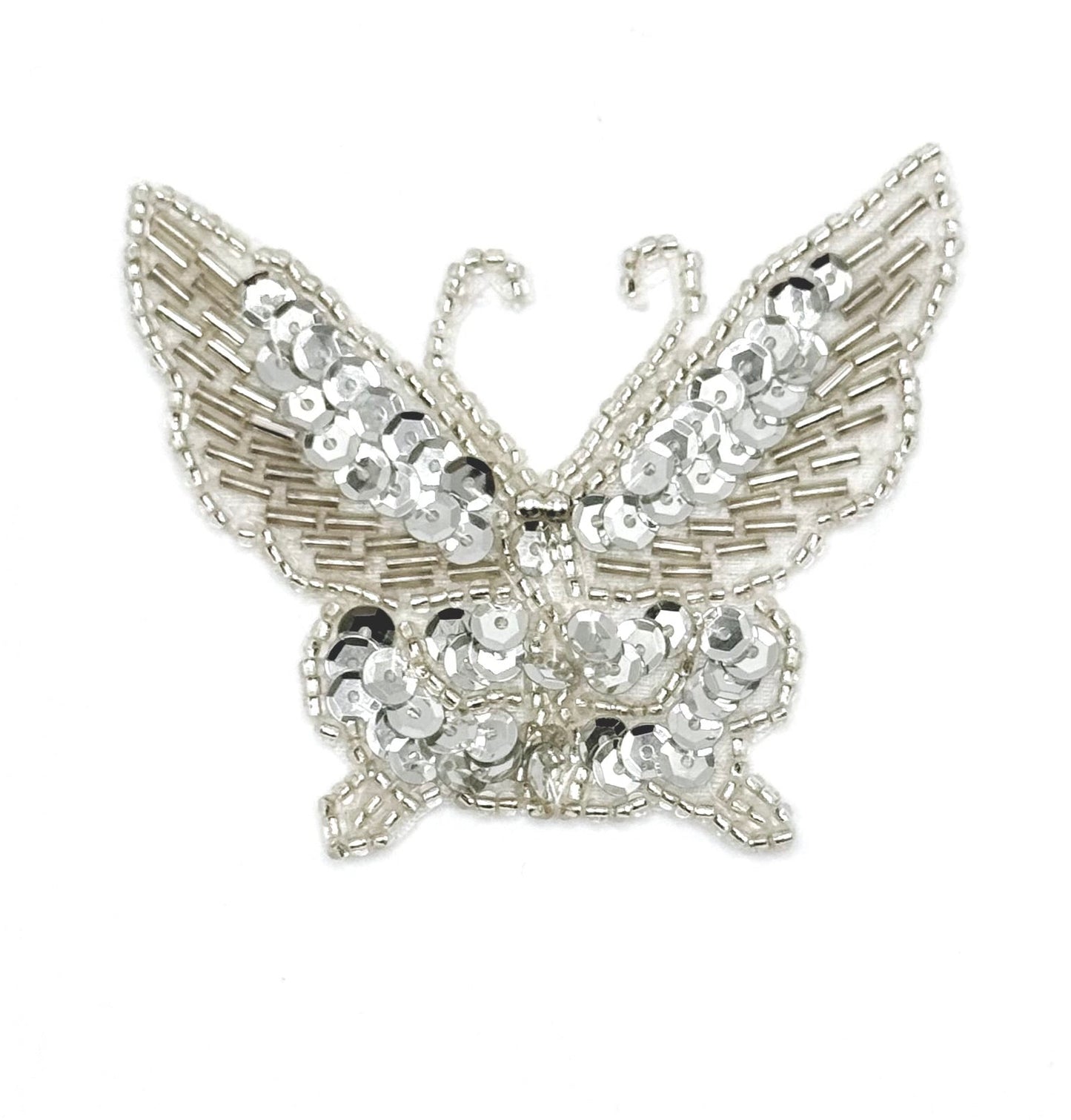 Silver butterfly with silver sequins and beads on a white background