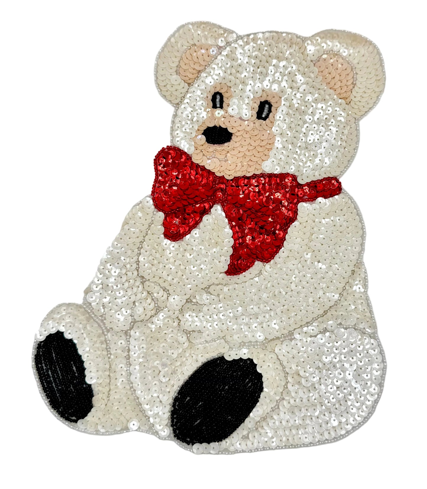 Sequined teddy bear with a red bow tie on a light gray background