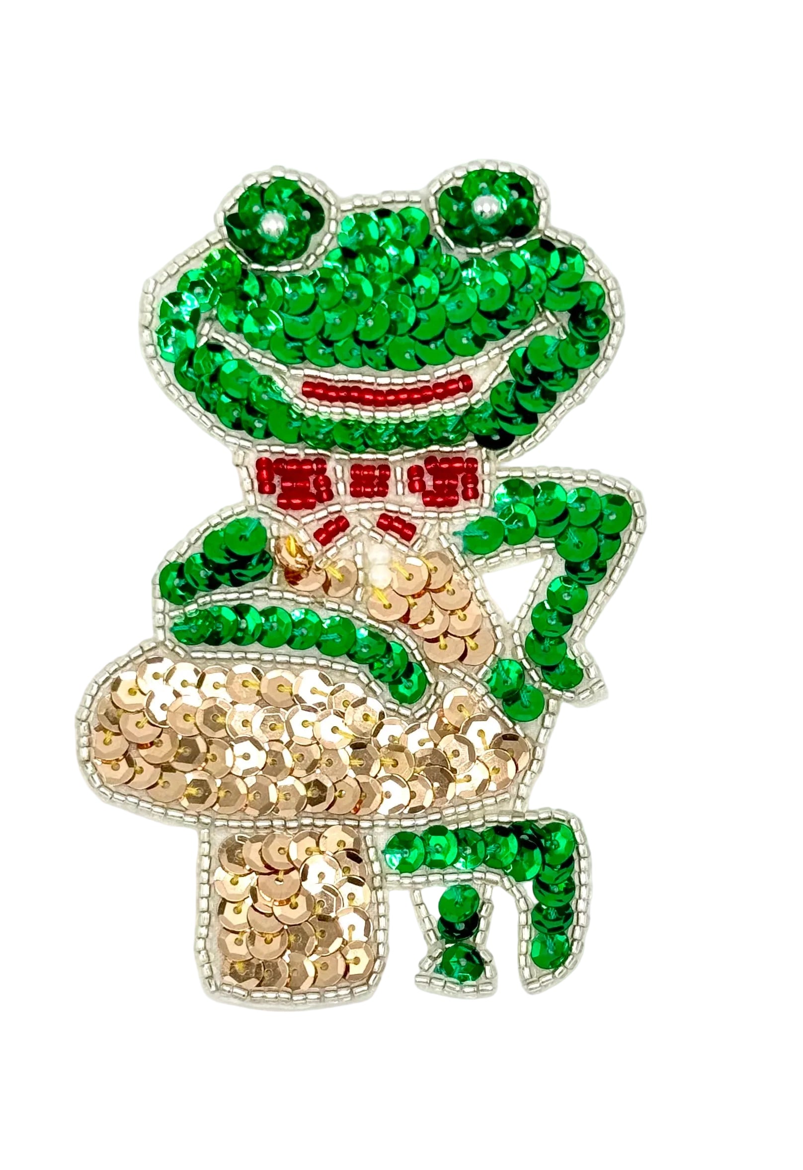 Decorative sequin frog with green and gold sequins and silver and red beads on a white background