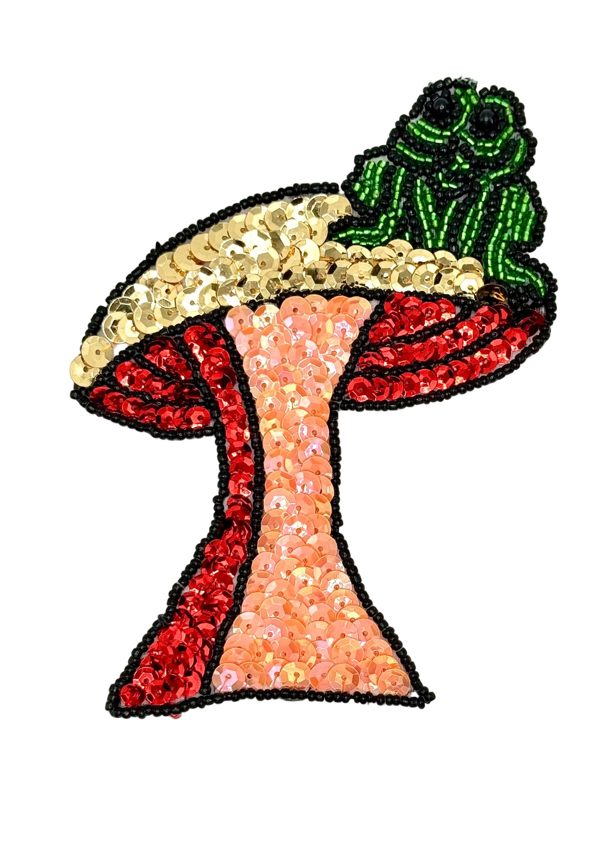 Colorful sequin patch of a mushroom with a green frog on a white background
