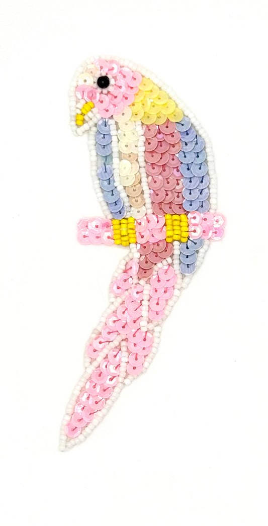 Decorative pen with a parrot design made of colorful beads on a white background