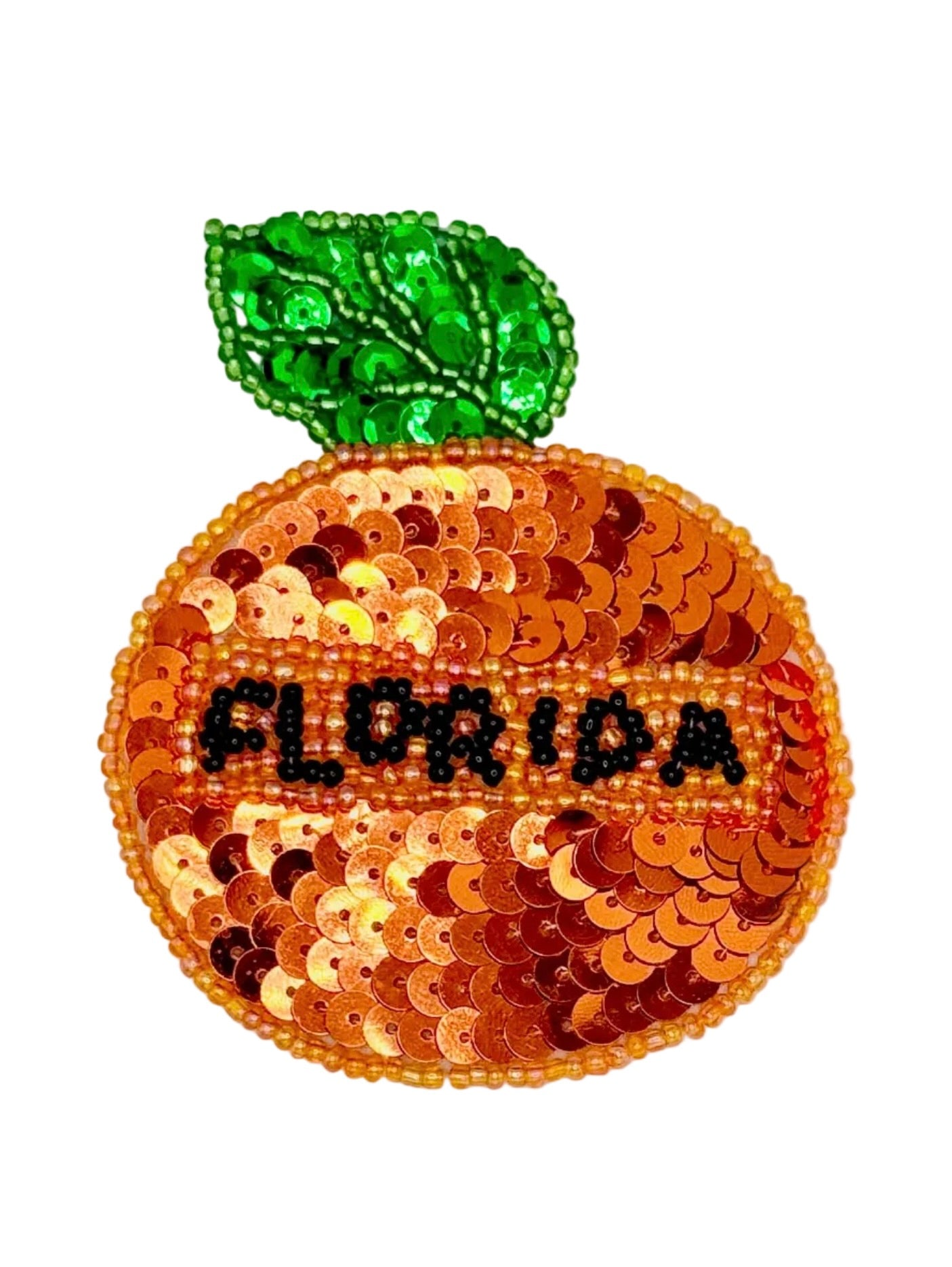 Sequined orange with 'FLORIDA' text and green leaf on a white background