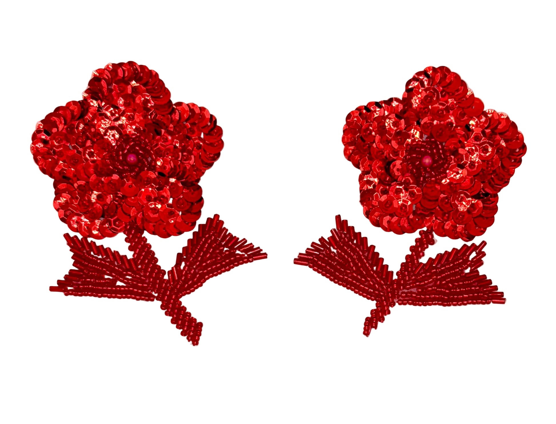 Two red sequin flowers on a white background