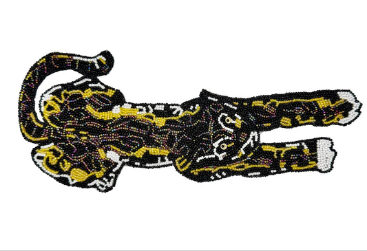 Beaded patch of a black panther with gold accents on a white background