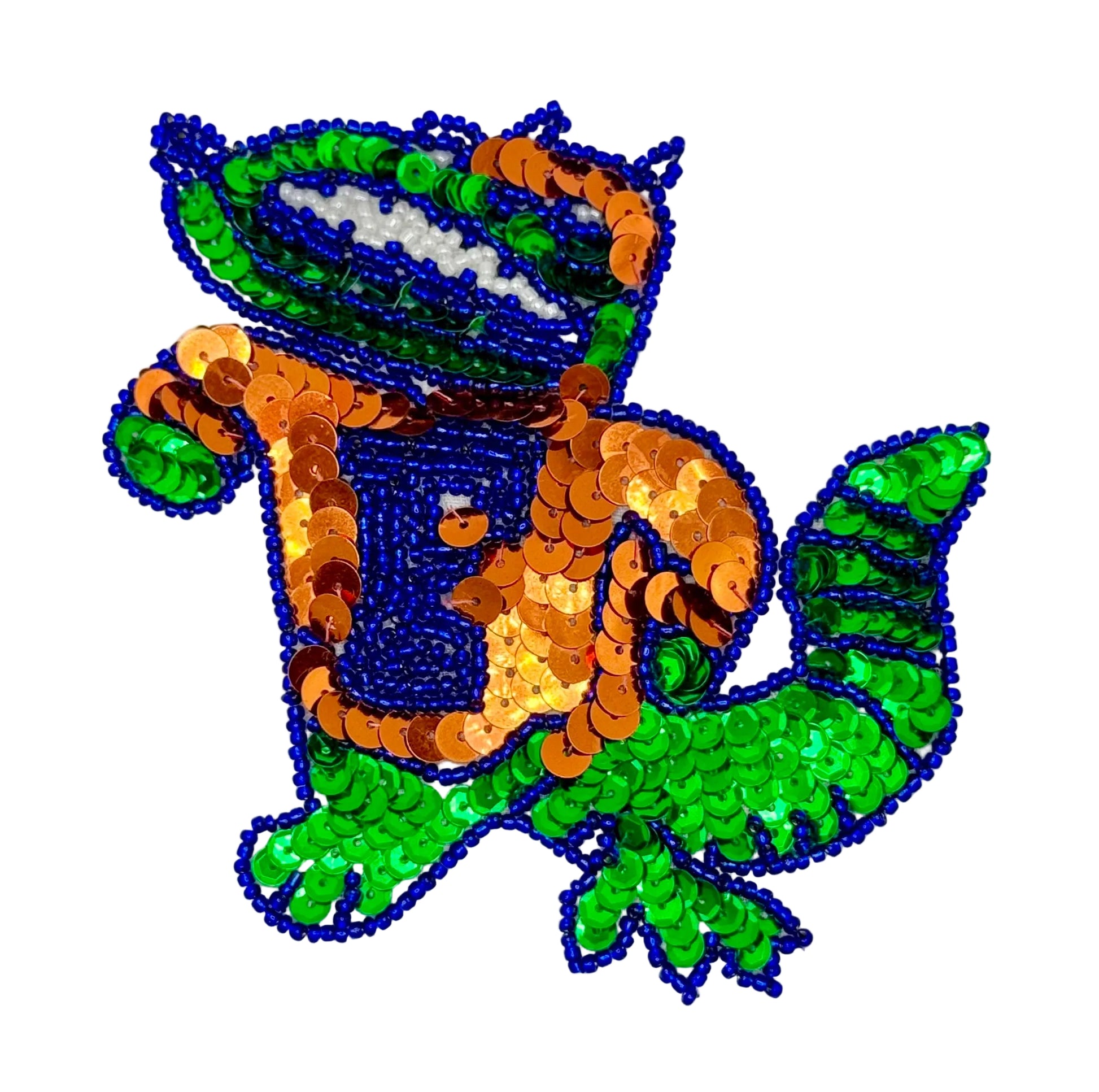 Sequined patch of a blue and green alligator  with orange accents on a light gray background