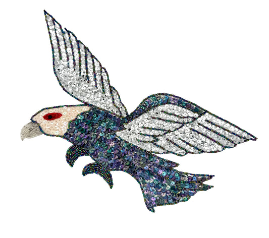 Decorative eagle design with sequins on a white background