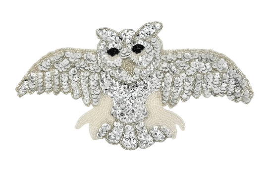Decorative owl patch  with sequins and beads on a white background