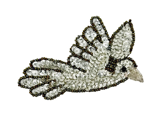 Decorative dove patch with sequins and beads on a white background