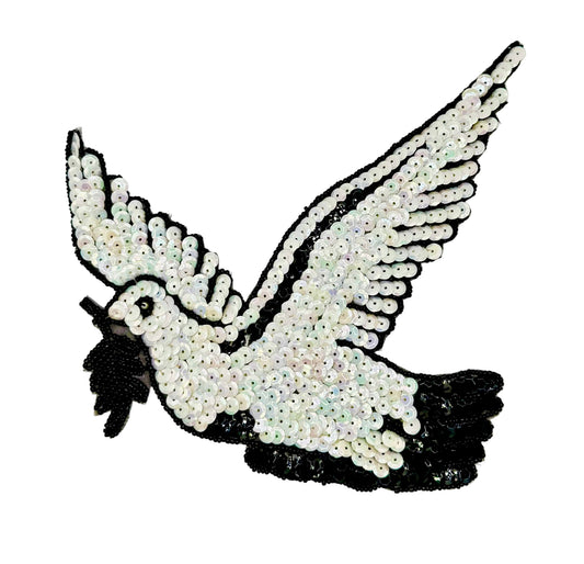 Sequined dove design on a white background