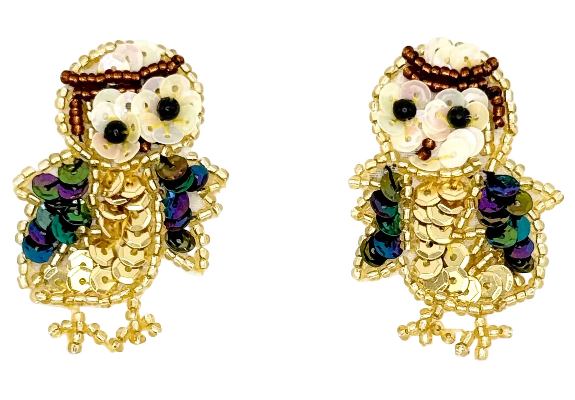 Pair of owl patches with sequins and beads on a white background